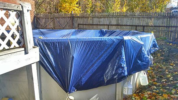 Above Ground Swimming Pool Closed, Covered, Winterized, Canoe, Fenced Backyard stock photo