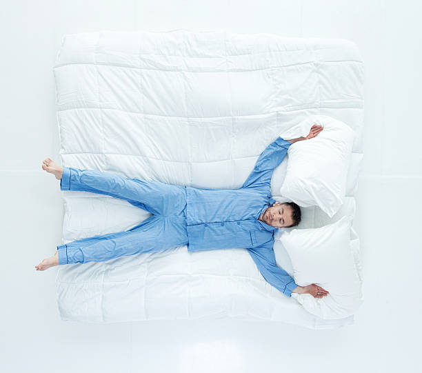 Above view of man sleeping on bed Above view of man sleeping on bedhttp://www.twodozendesign.info/i/1.png man sleeping in bed top view stock pictures, royalty-free photos & images