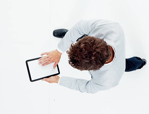above view of smart casual man using tablet - alleen jonge mannen stockfoto's en -beelden
