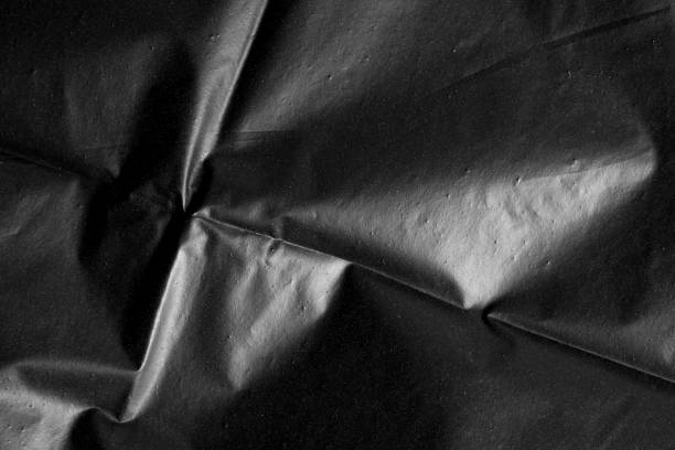 Abstract background crumpled plastic film texture black garbage bag stock photo