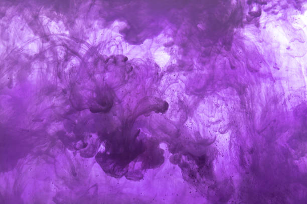 Abstract background picture with dark purple ink dissolving in water stock photo