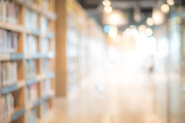 Abstract blurred public library interior space. blurry room with bookshelves by defocused effect. use for background or backdrop in business or education concepts stock photo