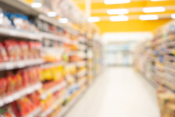 abstract blurred supermarket view of empty supermarket aisle, defocused blurry background with bokeh light in store. business concept. - supermercado imagens e fotografias de stock