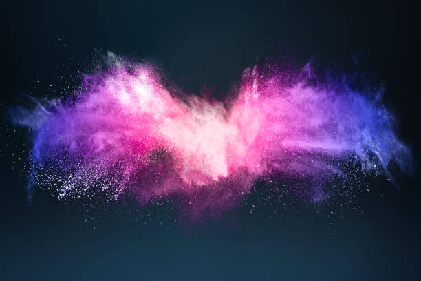 Abstract design of bright colored powder cloud on dark background stock photo
