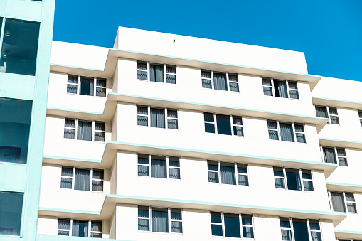 Abstract minimalist minimalism exterior architecture facade of art deco white turquoise teal colorful vintage retro residential building hotel