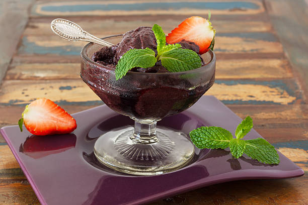 Acai pulp in glass with fresh mint and strawberry stock photo