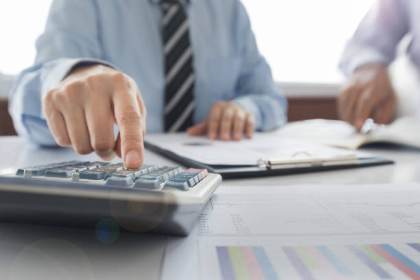 accounting Businessman using a calculator to calculate the numbers. Accounting , Accountancy, Calculation Concept. accounting ledger stock pictures, royalty-free photos & images