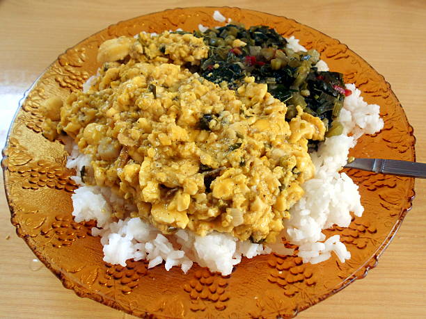ackee and rice in plate with callaloo stock photo
