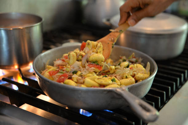 Ackee and Saltfish Jamaican national dish, ackee and saltfish, cooked in a traditional dutch pan over a flame. caribbean culture stock pictures, royalty-free photos & images