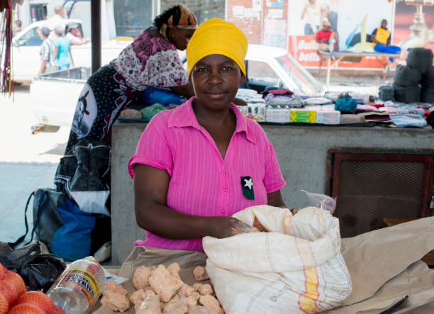acornhoek market woman selling stones stock photo