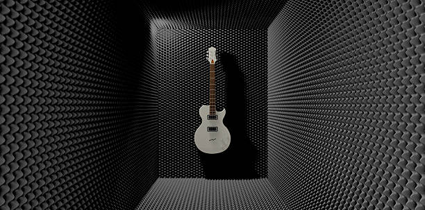Acoustic Foam Room With Mounted Electric Guitar An acoustic foam cladded sound room with a white electric guitar mounted on one of the walls soundproof stock pictures, royalty-free photos & images