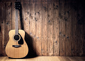 istock Acoustic guitar against blank wooden plank panel grunge background with copy space 1397013109