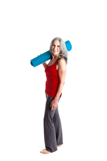 Active Senior Woman with Yoga Mat stock photo