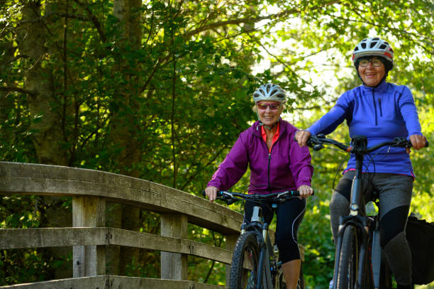 Active seniors cycling in nature stock photo
