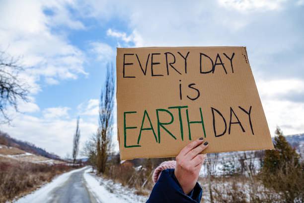 Activist holding sign protesting against climate change stock photo