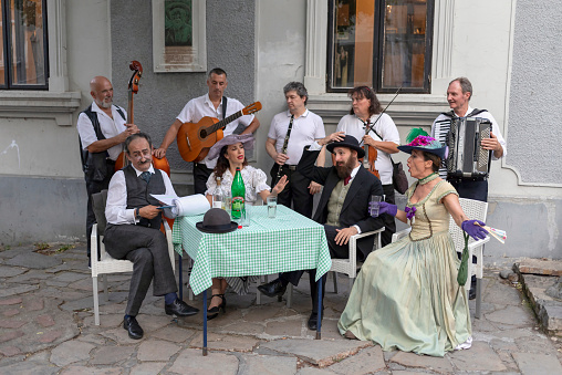 Belgrade, Serbia Jul 5, 2019: Actors recreating city life scenes from early 20th century at the touristic Skadarska Street also known as Skadarlija.