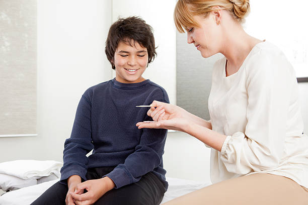 Acupuncturist With Young Male Patient stock photo