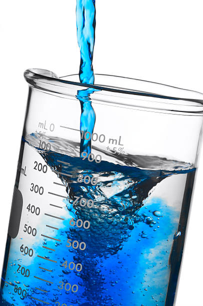 Adding Blue Chemical Solution to a Beaker. Isolated with Path. stock photo