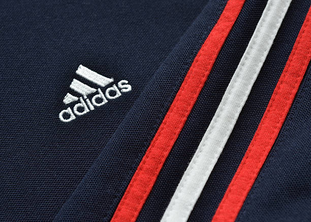 Adidas "Vancouver, Canada -- March 5, 2012:Close up of an Adidas jacket with logo and stripes. Adidas is a German based sports apparel company that is available worldwide." adidas stock pictures, royalty-free photos & images