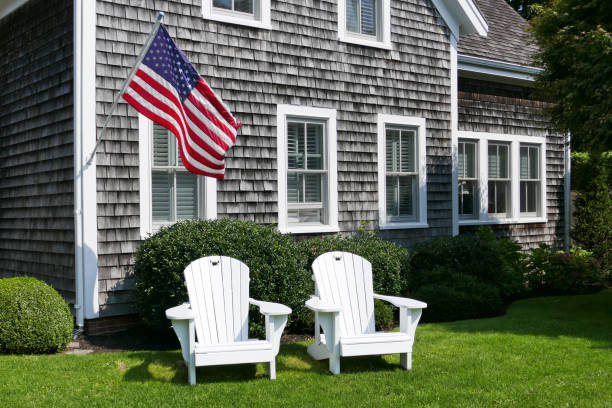Adirondack Chairs and American Flag Taken in a New England style front yard in Cape Cod, MA cape cod stock pictures, royalty-free photos & images