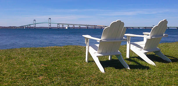 Adirondack Chairs by Bridge Two adirondack chairs by the Newport Bridge in RI. newport rhode island stock pictures, royalty-free photos & images