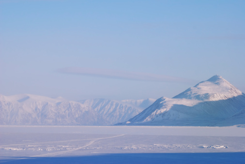 A scene in northern Baffin Island at 73 degrees north latitude.  Mountains in the distance are 20 kilometres away.  Admiralty Inlet at the village of Pond Inlet, Nunavut, Canada's arctic.
