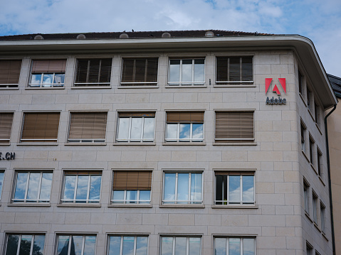 Basel, Switzerland - July 4 2022: Adobe Logo on side of Building. Adobe Inc. is an American multinational computer software company headquartered in San Jose.
