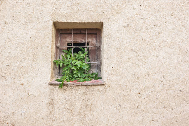 Adobe wall with window Adobe wall with square window adobe backgrounds stock pictures, royalty-free photos & images