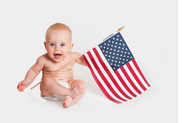 adorable baby girl holding an american flag on white stock photo