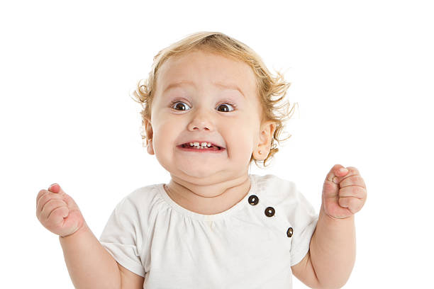 Adorable expressive little girl Sweet little girl grimacing at camera ecstatic stock pictures, royalty-free photos & images