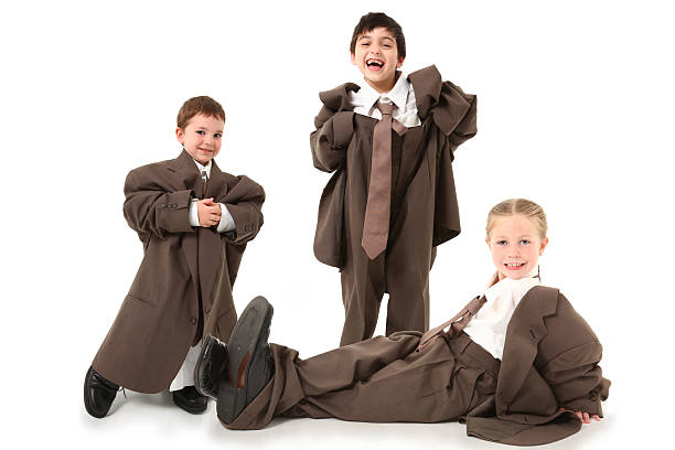 Adorable Kids in Over Sized Suits  oversized object stock pictures, royalty-free photos & images