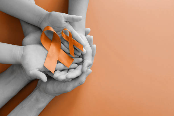 adult and children hands holding yellow gold ribbon, Sarcoma Awareness, Bone cancer, childhood cancer awareness Adult and child hands holding orange Ribbons,  Leukemia cancer and Multiple sclerosis, COPD and ADHD awareness, world kidney day multiple sclerosis stock pictures, royalty-free photos & images