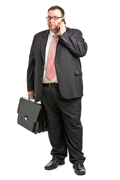 adult businessman adult man isolated on white fat man looks at the phone stock pictures, royalty-free photos & images