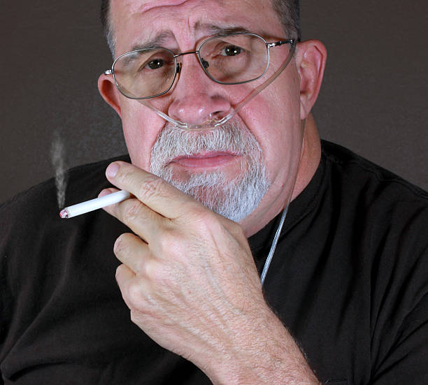 Adult Man Smoking with Cannula stock photo