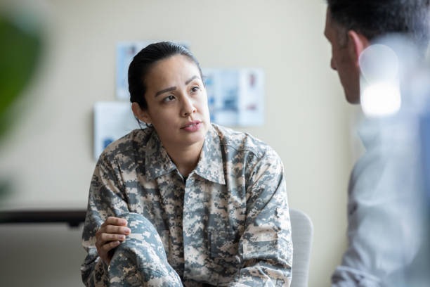 Adult military woman talking during one on one therapy session stock photo