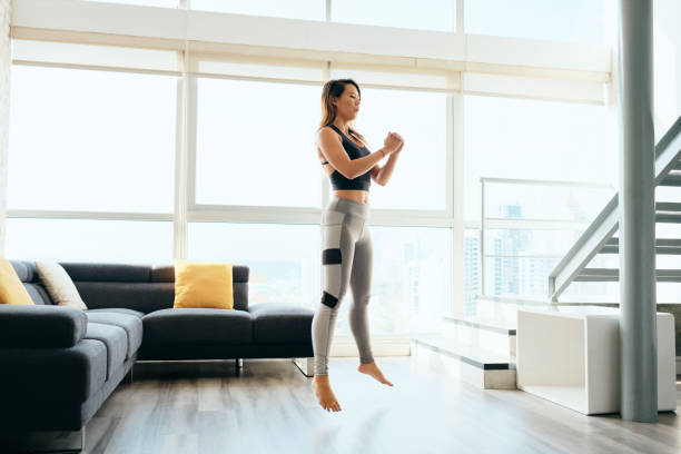 Adult Woman Training Legs Doing Squat and Jumping stock photo