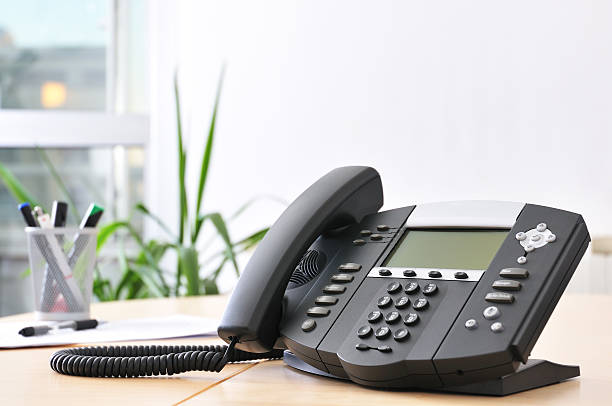 Advanced VoIP Phone Advanced managerial VoIP phone on beech desk. voip stock pictures, royalty-free photos & images