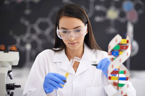 Advancement in genetics improving life Shot of a female scientist pouring liquid into a test tubehttp://195.154.178.81/DATA/shoots/ic_783863.jpg chemical engineering stock pictures, royalty-free photos & images