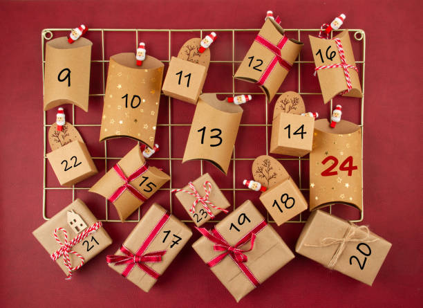 Advent calendar with craft carton boxes on the mesh board Advent calendar with craft carton boxes on the mesh board. Christmas celebration, xmas gifts, plastic free concept advent stock pictures, royalty-free photos & images