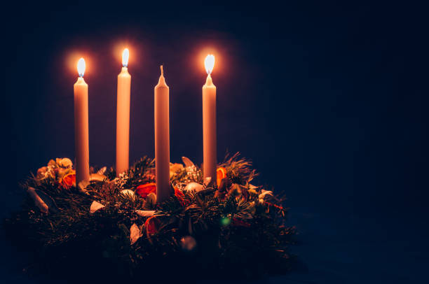 3. advent candle burning on advent wreath stock photo