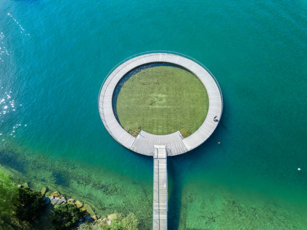Aerial image of the public swimming pool at the Zurich lake Zurich, Switzerland - 21. April 2022:  Aerial image of the public swimming pool at the Zurich lake side with a wooden circle toddler pond public service stock pictures, royalty-free photos & images