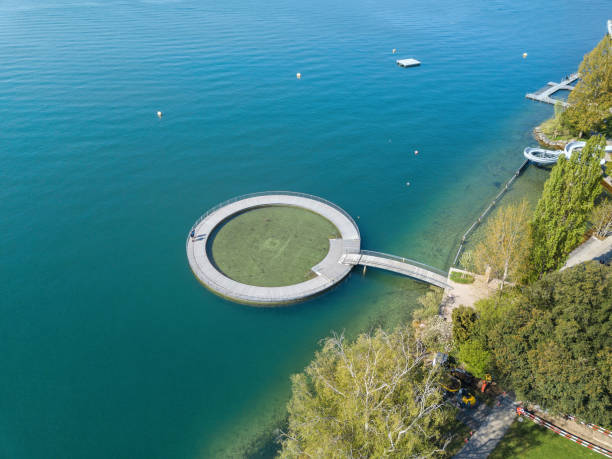 Aerial image of the public swimming pool at the Zurich lake Zurich, Switzerland - 21. April 2022:  Aerial image of the public swimming pool at the Zurich lake side with a wooden circle toddler pond public service stock pictures, royalty-free photos & images