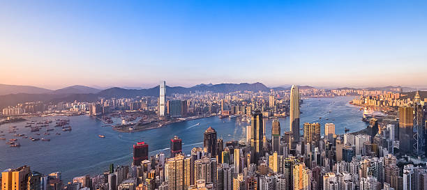 Aerial panorama of Hong Kong's Victoria harbour at sunset stock photo
