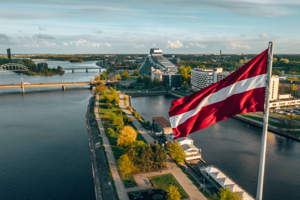 Aerial panorama of Riga city with a big Latvian flag Aerial panorama of Riga city with a big Latvian flag in the foreground. Golden hour. latvia stock pictures, royalty-free photos & images