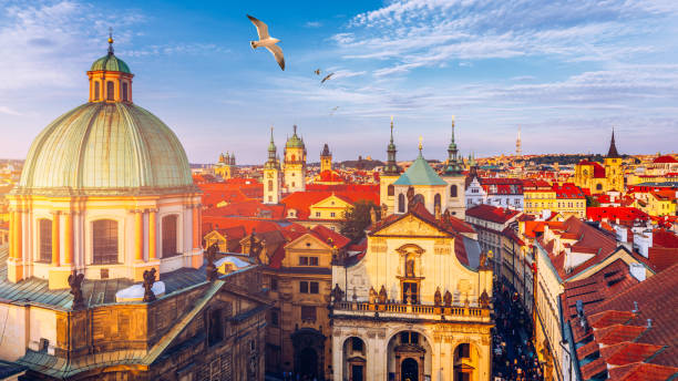 Aerial panorama view with flying birds of the Old Town in Prague, Czech Republic. Red roof tiles panorama of Prague old town.  Prague Old Town Square houses with traditional red roofs. Czechia. Aerial panorama view with flying birds of the Old Town in Prague, Czech Republic. Red roof tiles panorama of Prague old town.  Prague Old Town Square houses with traditional red roofs. Czechia. prague old town square stock pictures, royalty-free photos & images