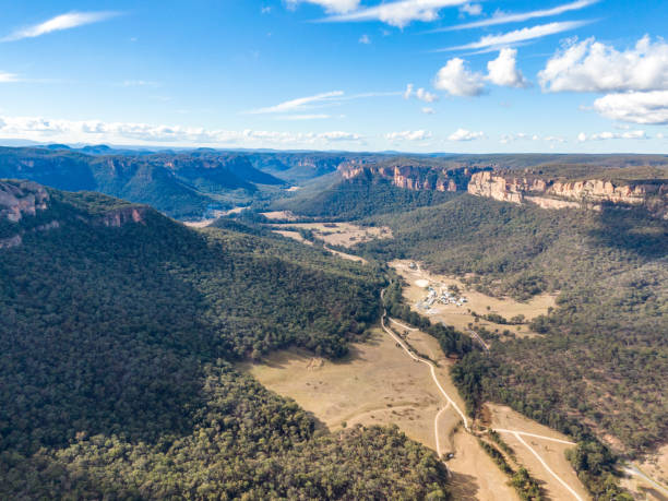 Aerial panoramic drone view of Wolgan Valley along the Wolgan River in the Lithgow Region of New South Wales, Australia. Part of the Blue Mountains near Sydney. stock photo