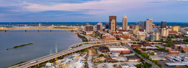 Aerial Perspective over Downtown Louisville Kentucky on the Ohio River Colorful bridges lead into the buildings and streets of downtown city center Louisville Kentucky kentucky stock pictures, royalty-free photos & images