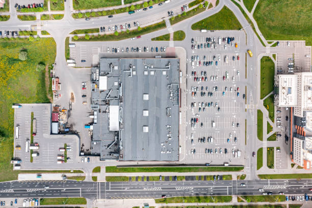 aerial photo of a large shopping mall in residential area with cars on parking lot stock photo
