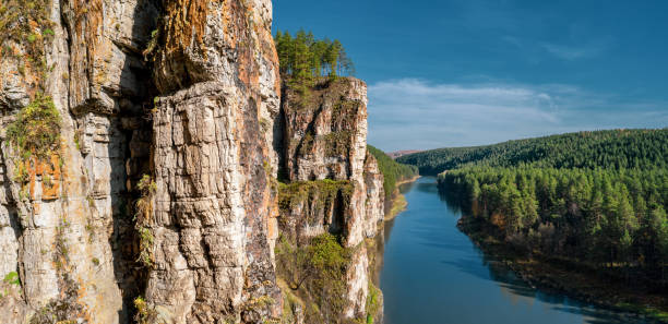 Aerial view; camera moving along rocky cliff of river stock photo
