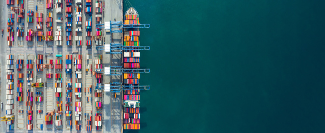 aerial view container ship in port at container terminal port ship of picture id1319941084?b=1&k=20&m=1319941084&s=170667a&w=0&h=x6xSnHWJvX66he 4zyV4ExocEpzp2k9q4EPq9exD4aI= - How Ship Chartering Works?